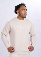 Man wearing a beige sweater with 'Lordeila' branding on a white background