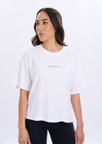 Woman wearing a white t-shirt with a logo on a white background