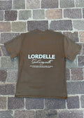 Brown t-shirt with 'LORDELLE God is my oath' text on a stone pavement background