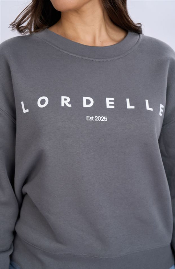 Grey sweatshirt with 'LORDELLIE' branding on a plain background